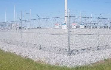 Ellenwood, GA Gravel Substation With Security Fence Maintained With Treated Bare Ground Spraying for Utility Power Company