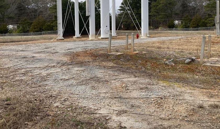 Dormant season vegetation control at a telecom tower site showing gravel access roads and cleared ground supporting year round access, equipment protection, and long term weed suppression on industrial infrastructure sites