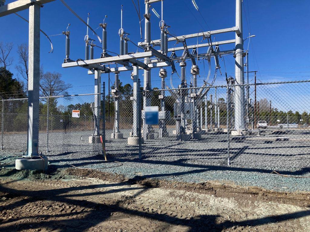 Industrial power substation switching facility with breakers, switches, and secured grounds, supported by industrial vegetation control to maintain access, safety, and regulatory compliance.