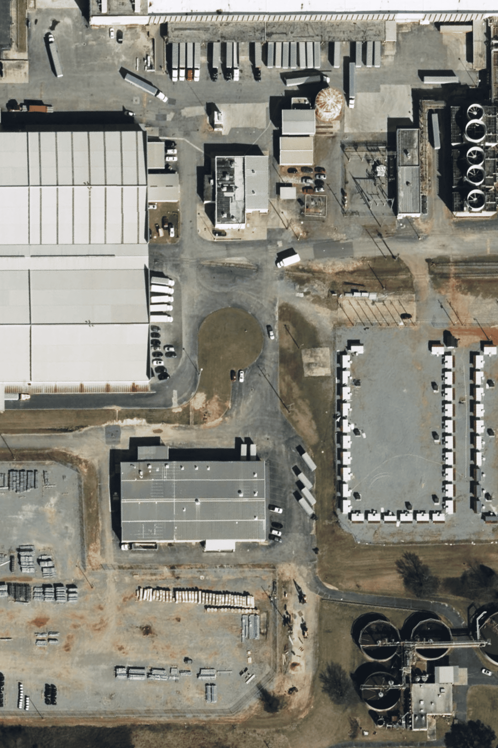 Aerial view of a large industrial facility with buildings, tanks, rail lines, roads, and storage yards, representing VegClear’s industrial vegetation control services that keep complex sites accessible, compliant, and operational year round.