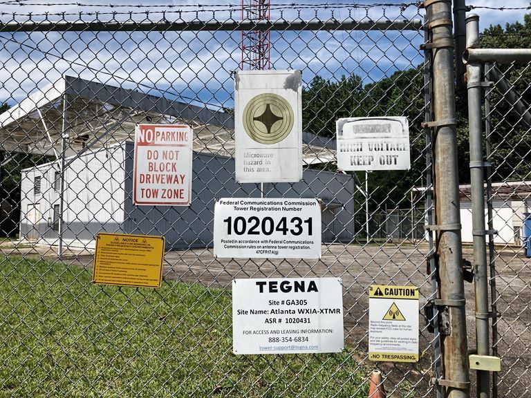 Close-up of a cleared fence line around a communication tower site, maintained by VegClear's herbicide treatment program. This proactive vegetation management supports Motorola’s advanced communication systems and ensures the safety and accessibility of the secured Atlanta facility