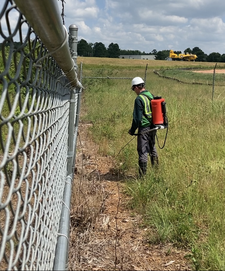 Technician Spraying Total Vegetation Control on Kudzu in Georgia