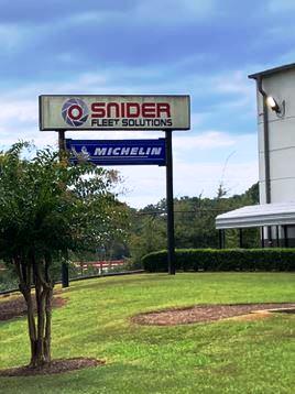 Exterior view of Snider Fleet Solutions in Ellenwood, Georgia, featuring the company’s main sign with the Snider Fleet Solutions and Michelin logos. The image shows the facility entrance and surrounding maintained landscape, representing the industrial site where VegClear provided vegetation management services to improve security and operational efficiency.