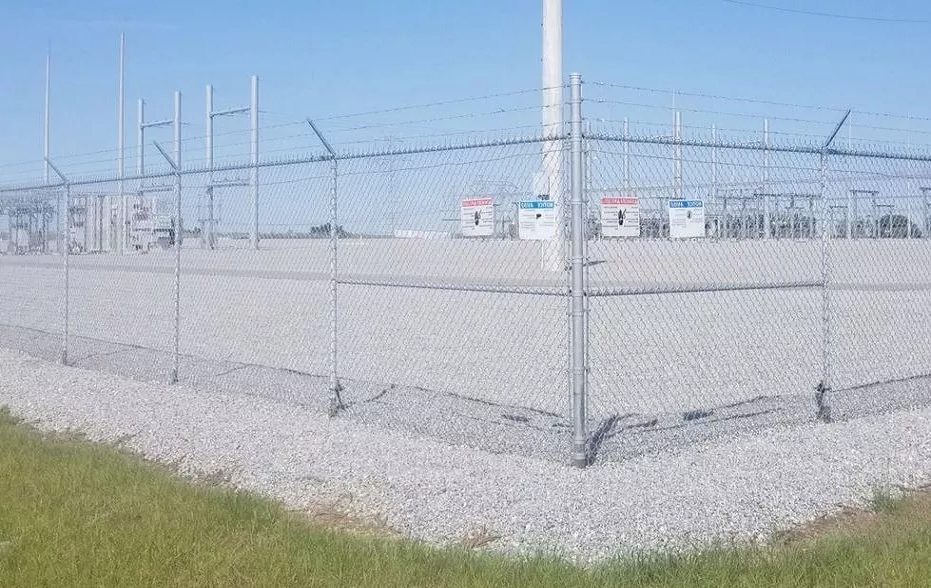 An image of a gravel fenced substation, demonstrating effective industrial vegetation management and commercial weed control in Georgia by VegClear.