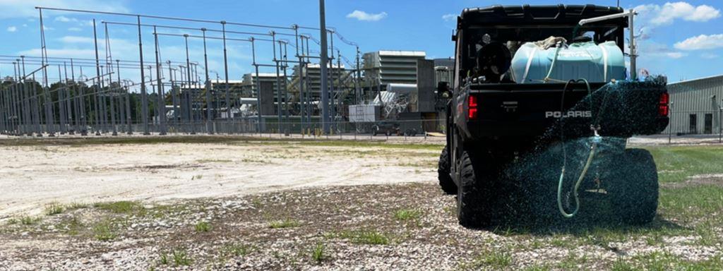 UTV-mounted spray system applying herbicides around an electrical substation. Licensed industrial weed control program supporting utility infrastructure, gravel surfaces, access routes, and perimeter maintenance.