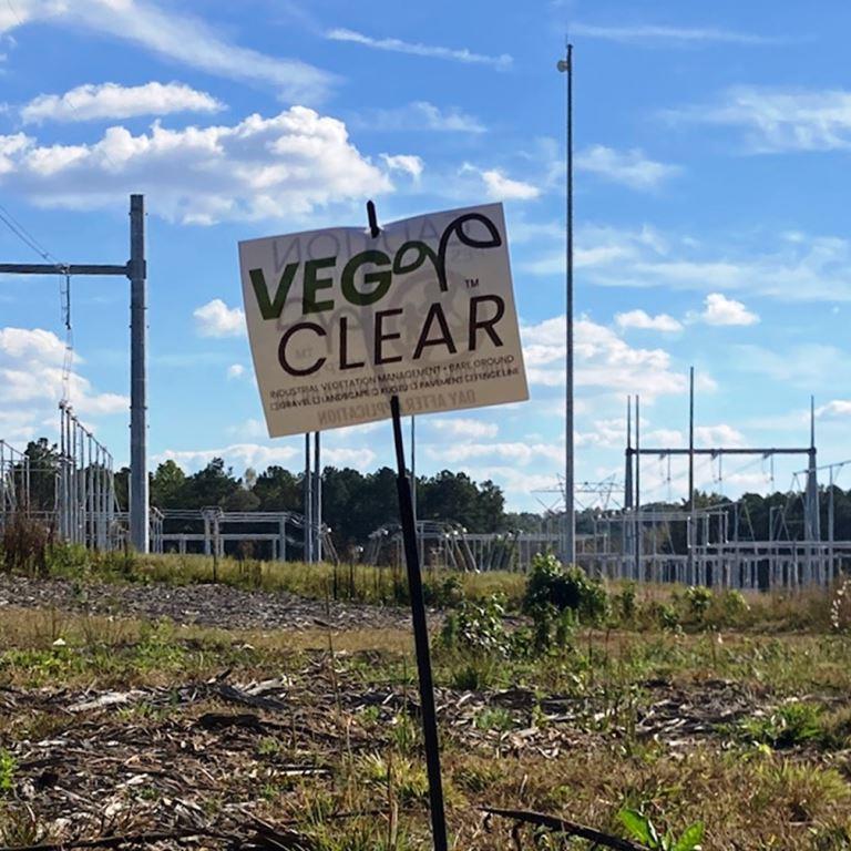 VegClear site marker posted at an electrical substation, showing industrial vegetation management work supporting bare ground control, asset protection, and compliance around critical utility infrastructure