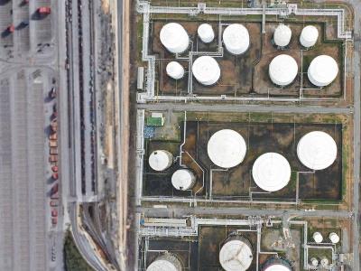Rail siding at fuel tank farm with no invasive vegetation, gravel apron treated with herbicide, safe access to offload valves and containment berms maintained by certified applicators