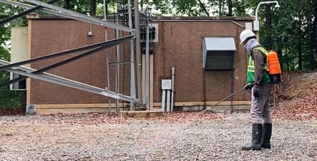 Expert VegClear technicians effectively applying spot sprayed herbicides to this industrial property for optimal weed control year-round, ensuring no growth around critical equipment and power generation areas.