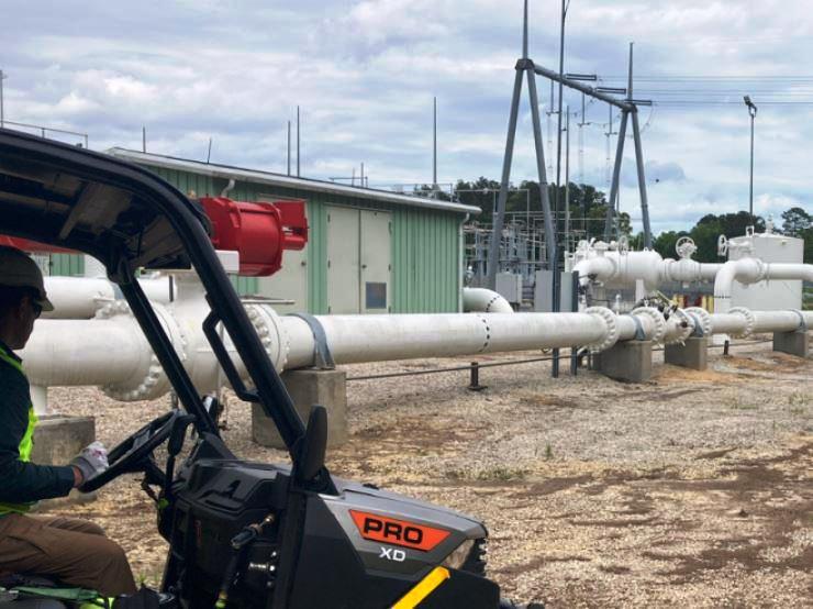 Licensed technician sprayed this site with mounted herbicide sprayer and applied vegetation control treatment along the perimeter of an industrial property. Polaris utility vehicles equipped with a reel and broadcast spray system for precise chemical application across paved and gravel areas. This image represents VegClear’s industrial vegetation management services designed for distribution centers, warehouses, and manufacturing facilities, where safe, controlled herbicide application keeps large properties clear, accessible, and compliant with operational and safety standards.