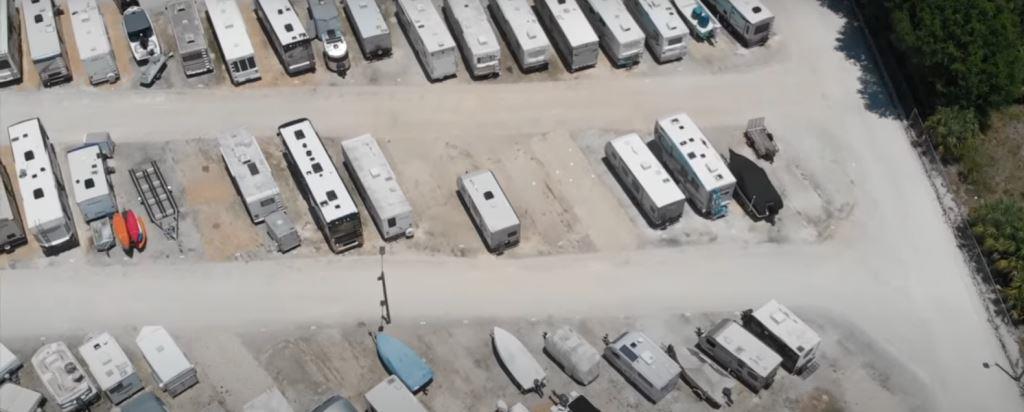 Overhead view of a Norcross, GA self storage facility outdoor parking lot showing RVs, boats, and trailers stored on gravel. VegClear provides total vegetation control across gravel surfaces, fence lines, and perimeter areas for clean, professional storage operations