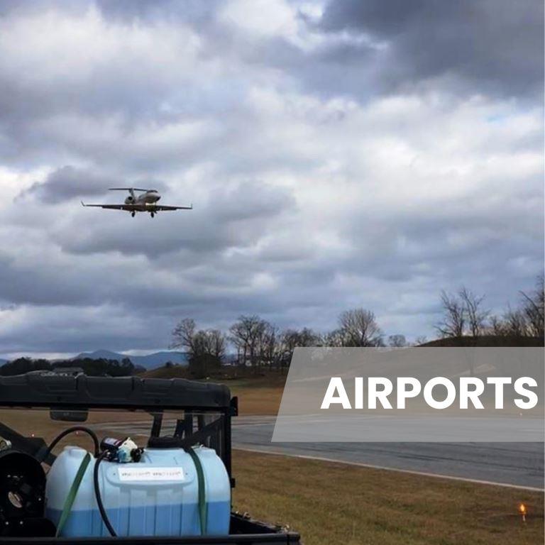 UTV mounted spray rig staged along an airport runway perimeter as an aircraft approaches, showing coordinated vegetation control for airfield safety and compliance