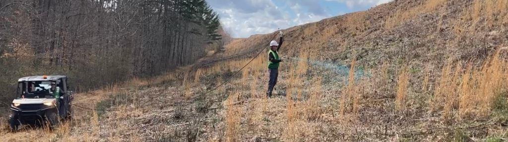 Licensed applicator performing targeted herbicide brush control on steep right of way embankment slope at an industrial site in Georgia.