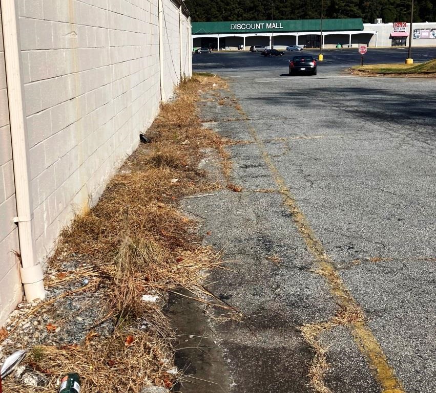 Commercial Property Industrial Vegetation Control: Gravel Perimeter With Dead Weeds After Treatment