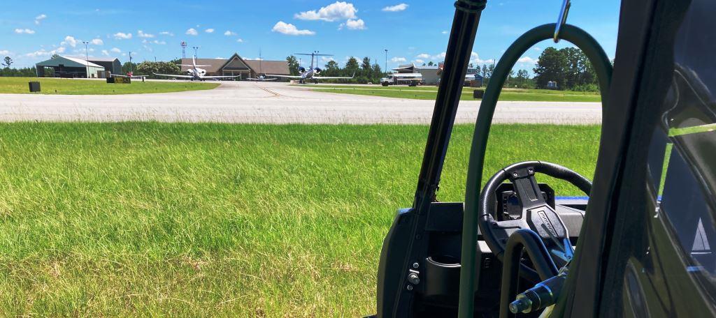 VegClear herbicide application unit positioned along active airport taxiway in Georgia, controlling vegetation near jet operations and runway areas for safe, compliant airfield maintenance.