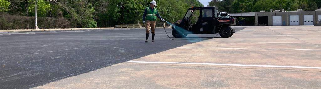Applicator uses a UTV mounted sprayer to treat weeds along pavement joints and parking lot seams. Precision herbicide service helps maintain clean surfaces, curb appeal, access lanes, and reduced weed regrowth at commercial facilities.
