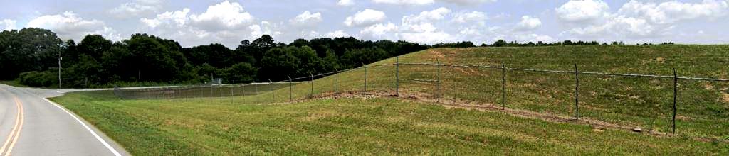 Image 2 (After) An airport fence line after professional herbicide applications by licensed applicators, The base of the fence is cleared of all vegetation, leaving clean, bare ground for improved access, visibility, and long-term weed prevention. This showcases herbicide expertise in airport vegetation control services
