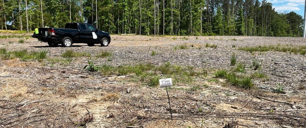 Industrial gravel and utility-style operational yard undergoing bare ground vegetation control treatment by VegClear. Herbicide program focused on long-term weed suppression, gravel lot maintenance, and reduced mowing requirements for industrial facilities and infrastructure sites.
