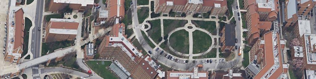 Aerial view of a large school or university campus quad with sidewalks, open turf, and academic buildings, ideal for scheduled herbicide treatments and vegetation control by VegClear’s school campus vegetation management program in Georgia