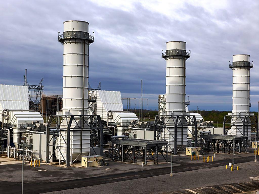 Industrial power plant facility with large cooling stacks and critical infrastructure. VegClear provides licensed vegetation management and weed control around substations, transmission sites, and energy facilities in Georgia and the Southeast.