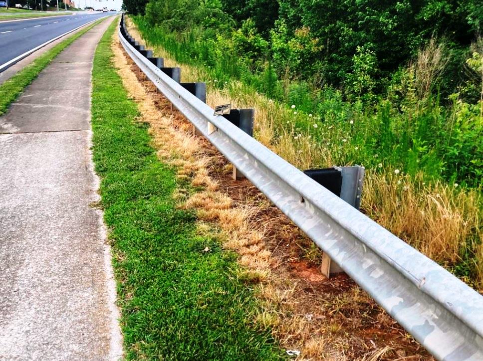 Roadside herbicide applicator spraying weeds