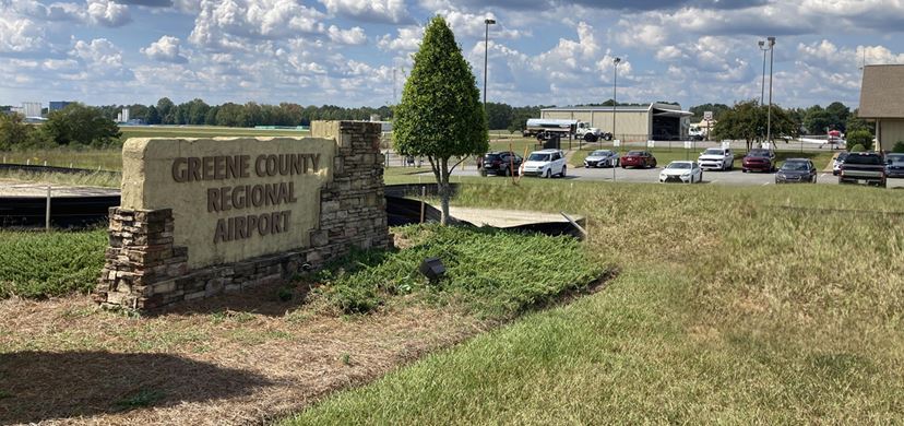 Overgrown weeds and wild roadside vegetation at municipal airport in Greensboro, Georgia. Eradication efforts are helping eliminate invasive kudzu along airport perimeter fence.