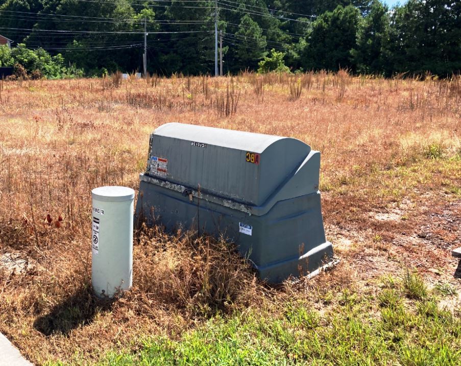 Gravel Cell Tower Utility Pad: Controlled Weeds and Dead Vegetation After Herbicide Application