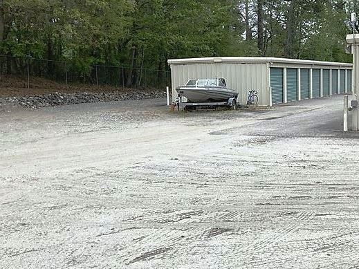 Self-storage facility with expanded gravel parking areas, designed for long-term vehicle and equipment storage. Weed control services prevent invasive plant growth, reducing surface maintenance and enhancing site appearance. Specialized herbicide applications for self-storage expansion projects across Georgia