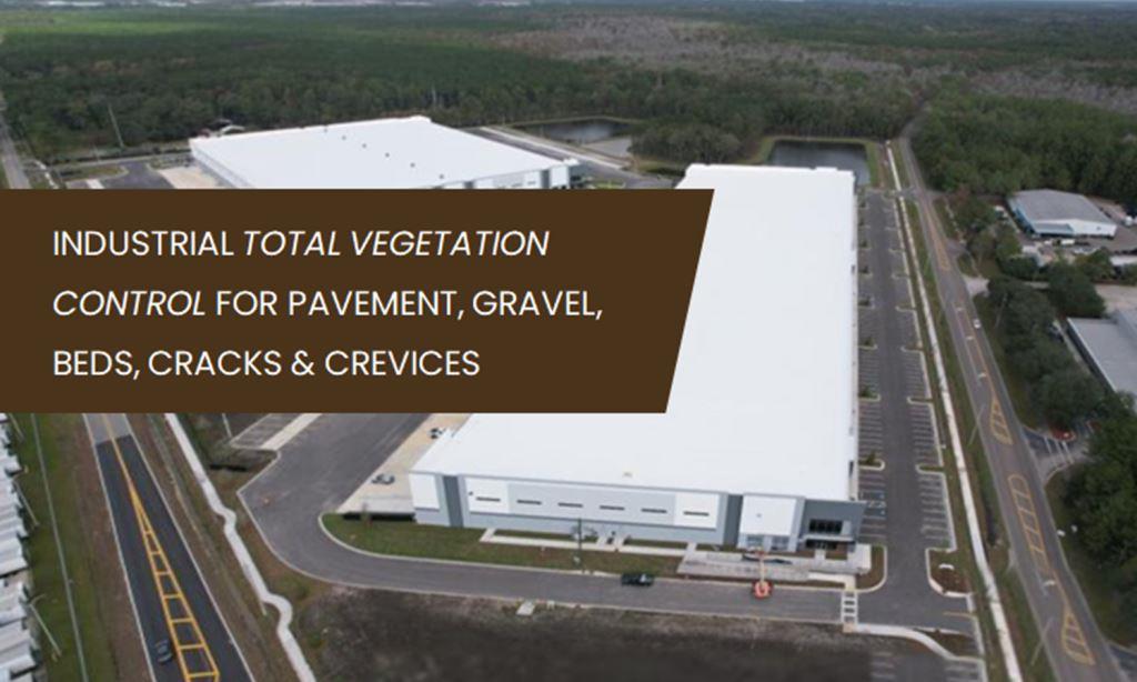 Aerial view of an industrial distribution facility with paved lots and gravel areas, highlighting VegClear’s total vegetation control services for pavement cracks, gravel staging yards, parking lots, fence lines, and industrial beds across Georgia, South Carolina, and the Southeast US.