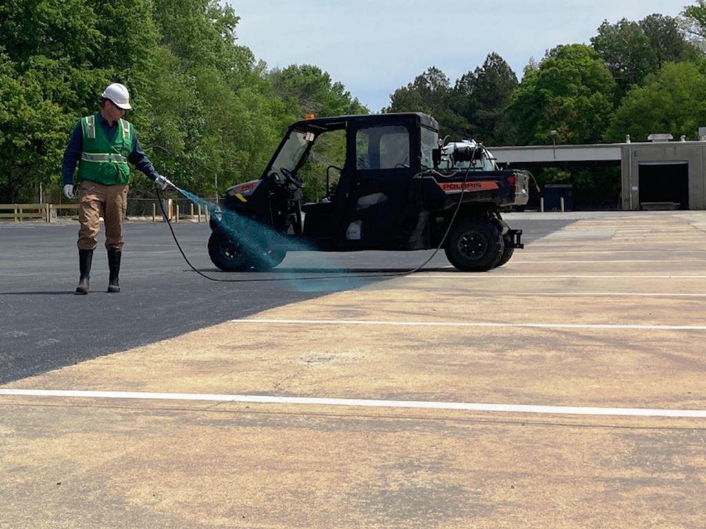 Licensed applicator uses a UTV mounted sprayer to treat weeds in parking lot seams and pavement transitions. Directed herbicide application supports cleaner surfaces, improved appearance, reduced maintenance, and longer weed control intervals.