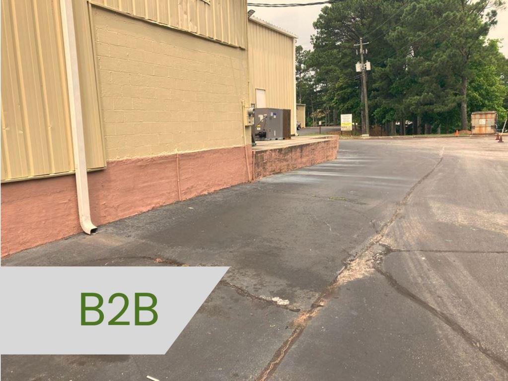 overgrown industrial lot requires monthly grass and weed control, vegetation management, herbicide spraying, treatments