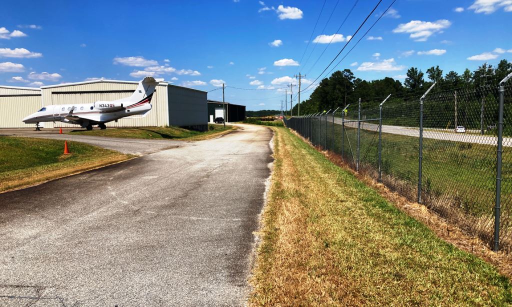 Airport vegetation control client with professional applications of commercial fence line and pavement weed control VegClear