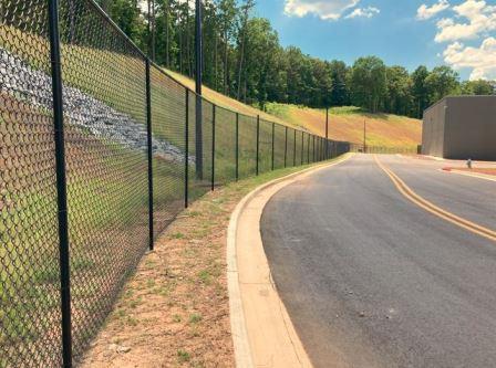 Fence line herbicide application by VegClear ensures industrial and commercial property upkeep