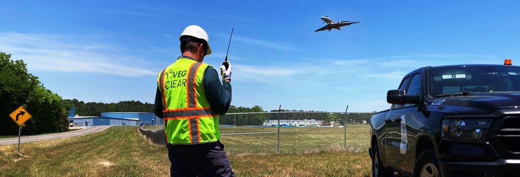 Fences Displaying the Results of Herbicide Treatment Around a Perimeter Security Barrier Kept Clear by Technicians Spraying Linearly Along East Georgia Airport Chain-Link Fence