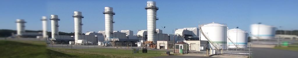 A natural gas-fired power plant in Georgia featuring multiple combustion turbine stacks, industrial storage tanks, and secured fencing. This energy infrastructure site supports regional grid power generation with modern equipment and clean-burning fuel for industrial electricity output.